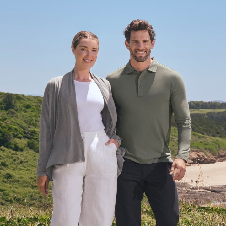 Man and woman standing outdoors with a scenic background