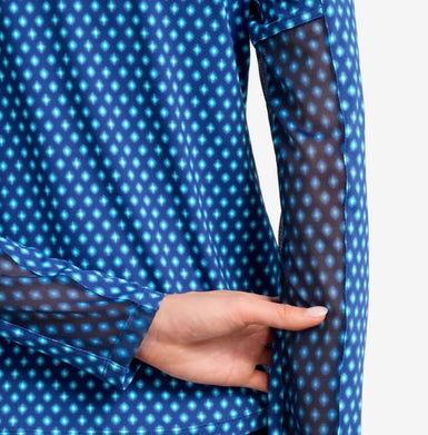 Blue polka dot shirt with sheer long sleeves, hand pointing at the sheer fabric.
